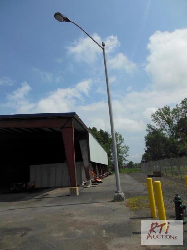 lot 115 image: (2) spare arms for light poles. Arms are 8 fe...