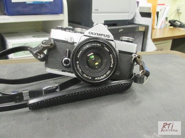 lot 99 image: Olympus OM-1 35mm camera, condition unknown. ...