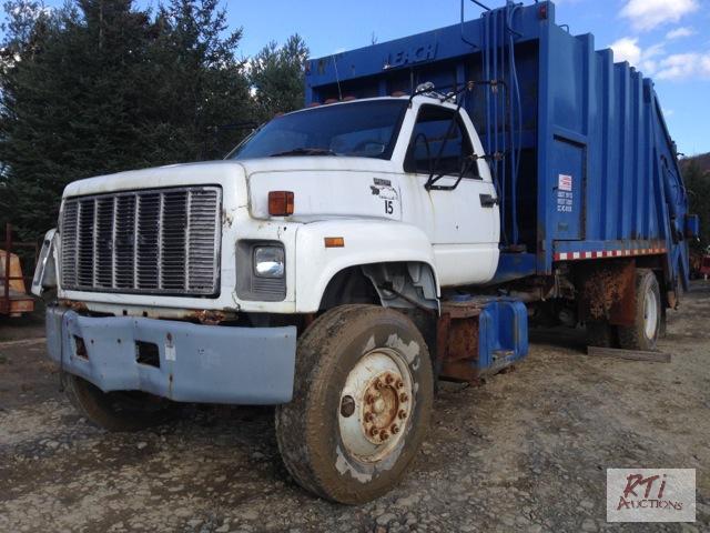 lot 10 image: 1994 GMC C7H SA with a Leach Packer Body. VIN...