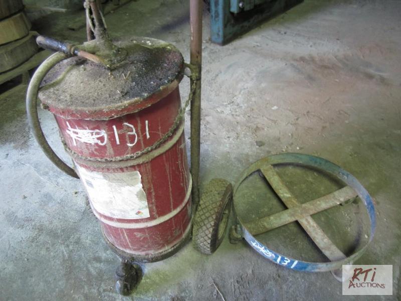 lot 131 image: (2) Barrel dollies and drum of oil...