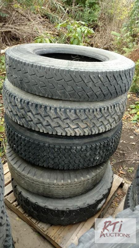 lot 32 image: (24) Truck Tires. Mixed sizes. Some mounted. ...